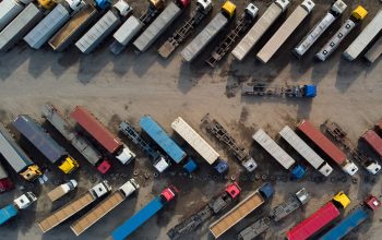 aerial view of a parking lot of trucks ready for loading containers and delivery.