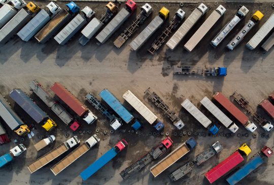 aerial view of a parking lot of trucks ready for loading containers and delivery.