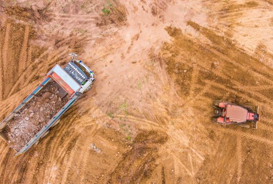 dump-truck-unloads-soil-on-the-construction-site-2022-11-09-04-50-20-utc